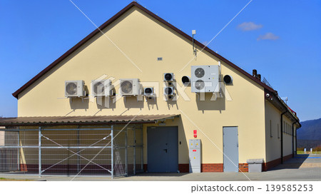 Air conditioners on the wall of a commercial building. Air conditioners on the wall of a commercial building. 139585253