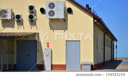 Air conditioners on the wall of a commercial building. Air conditioners on the wall of a commercial building. 139585254