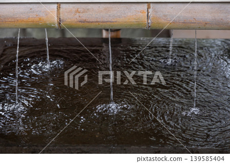 [Japan] Water dripping from a bamboo pipe at the purification fountain of Matsudo Shrine in Chiba Prefecture. 139585404