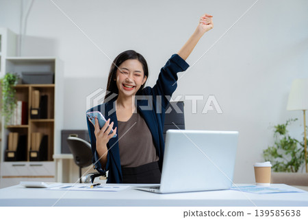 Overjoyed charming excited woman business woman worker using smartphone. Overjoyed charming excited woman business woman worker using smartphone. 139585638