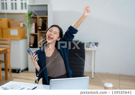 Overjoyed charming excited woman business woman worker using smartphone. Overjoyed charming excited woman business woman worker using smartphone. 139585641