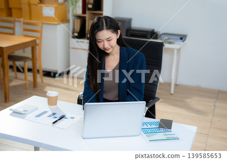 woman using mobile phone in modern office with laptop and digital tablet computer. woman using mobile phone in modern office with laptop and digital tablet computer. 139585653