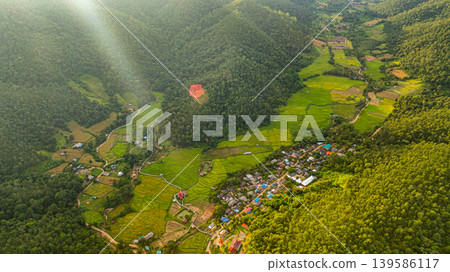 Aerial top view of Yellow rice terraces beside the mountain village 139586117