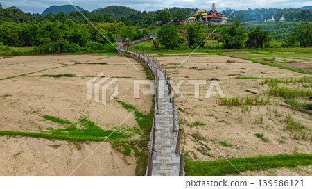 Aerial view of beautiful temple at Boon Ko Ku So Bridge beautiful bamboo bridges Aerial view of beautiful temple at Boon Ko Ku So Bridge beautiful bamboo bridges 139586121