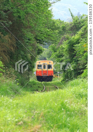 A Kiha train running through a mountainous area on the Kominato Railway. A Kiha train running through a mountainous area on the Kominato Railway. 139586330