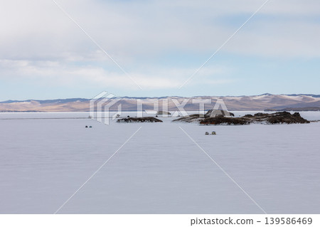 Frozen Lake Baikal Small Sea with islands and winter mountains under cloudy sky Frozen Lake Baikal Small Sea with islands and winter mountains under cloudy sky 139586469