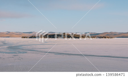 Frozen Lake Baikal Maloye More strait with island and winter steppe hills 139586471