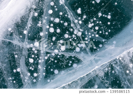 Frozen Lake Baikal ice texture with trapped bubbles and cracks, top view Frozen Lake Baikal ice texture with trapped bubbles and cracks, top view 139586515