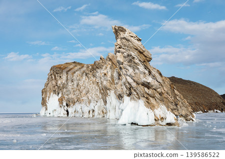 Winter ice and rocky cliff on Ogoy Island in Lake Baikal under blue sky Winter ice and rocky cliff on Ogoy Island in Lake Baikal under blue sky 139586522