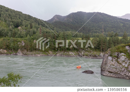 Rafting boat on Katun River in Altai Mountains valley with forested hills Rafting boat on Katun River in Altai Mountains valley with forested hills 139586556
