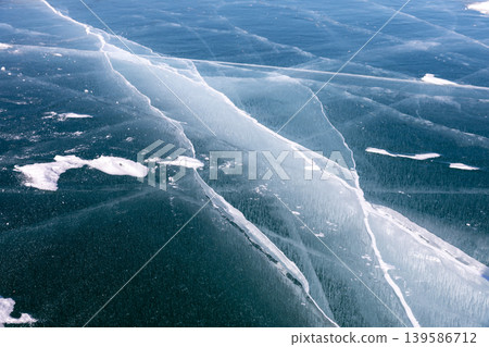 Aerial view of cracked blue ice surface on Lake Baikal in winter, Siberia Aerial view of cracked blue ice surface on Lake Baikal in winter, Siberia 139586712