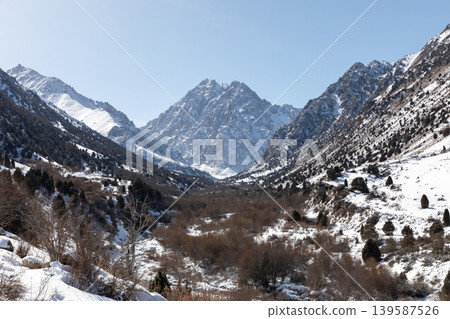 Winter mountain landscape in Issyk-Ata Gorge with snowy peaks and clear sky Winter mountain landscape in Issyk-Ata Gorge with snowy peaks and clear sky 139587526