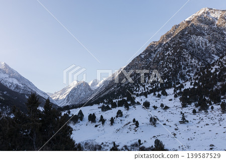 Winter mountain landscape of Alamedin Gorge with snowy peaks and clear sky 139587529
