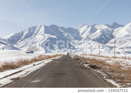 Scenic winter road through snowy Tian Shan mountains near Naryn, Kyrgyzstan 139587532