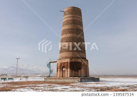 Burana Tower ancient minaret in Tokmok with snowy landscape and mountains 139587534