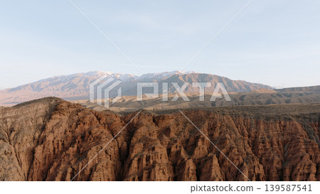 Kok-Moinok Canyon panoramic landscape with red rock cliffs and distant mountains Kok-Moinok Canyon panoramic landscape with red rock cliffs and distant mountains 139587541