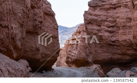 Kok-Moinok Canyon narrow red sandstone gorge with rocky trail in Kyrgyzstan 139587542