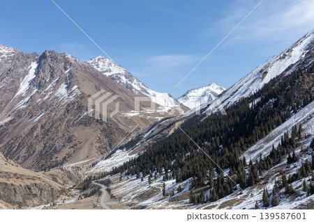 Scenic Barskoon Gorge mountain valley with snowy peaks and winding road, Kyrgyzstan Scenic Barskoon Gorge mountain valley with snowy peaks and winding road, Kyrgyzstan 139587601