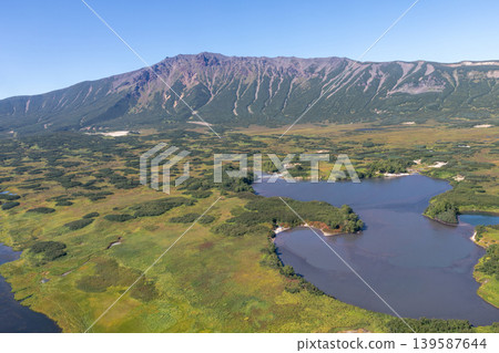 Aerial view of Uzon Volcano caldera landscape and lake, Kamchatka Peninsula Aerial view of Uzon Volcano caldera landscape and lake, Kamchatka Peninsula 139587644