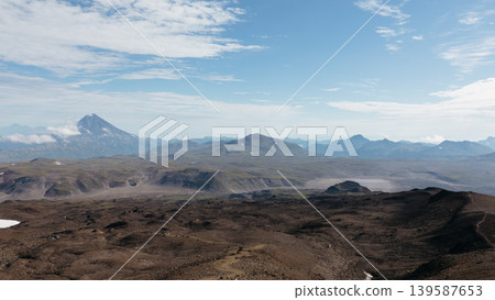Volcanic highland landscape and distant peaks in Kamchatka under blue sky Volcanic highland landscape and distant peaks in Kamchatka under blue sky 139587653