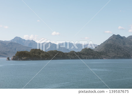 Scenic coastal mountains and calm sea in Velyuchinskaya Bay, Kamchatka Peninsula Scenic coastal mountains and calm sea in Velyuchinskaya Bay, Kamchatka Peninsula 139587675