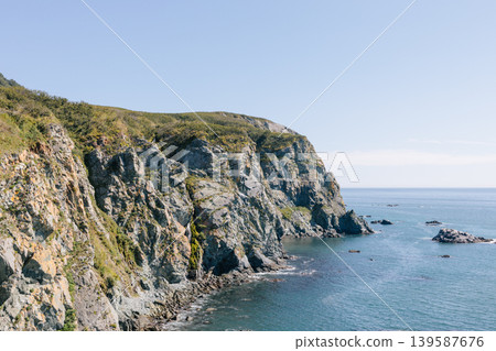 Velyuchinskaya Bay rocky sea cliffs and calm ocean coastline on sunny day Velyuchinskaya Bay rocky sea cliffs and calm ocean coastline on sunny day 139587676