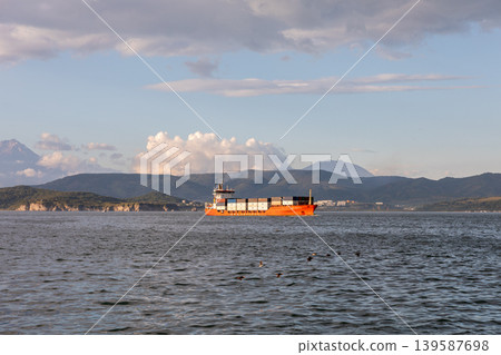Cargo container ship sailing in Avacha Bay with mountains, Kamchatka skyline 139587698