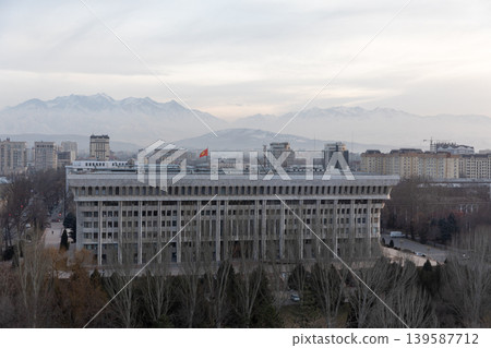 Bishkek city skyline with government building and Tian Shan mountains at dusk Bishkek city skyline with government building and Tian Shan mountains at dusk 139587712