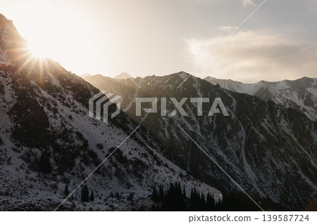 Sunset over snowy Tian Shan mountains in Ala Archa National Park valley Sunset over snowy Tian Shan mountains in Ala Archa National Park valley 139587724