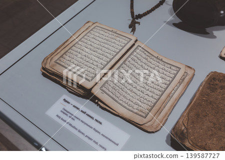 Antique Quran manuscript on museum display in Bishkek with Arabic calligraphy pages Antique Quran manuscript on museum display in Bishkek with Arabic calligraphy pages 139587727