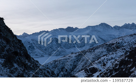 Winter mountain landscape in Chunkurchak Valley with snowy peaks at dusk Winter mountain landscape in Chunkurchak Valley with snowy peaks at dusk 139587729