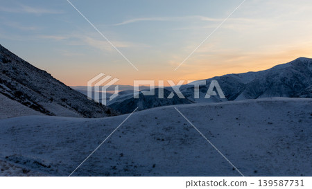 Winter sunset panorama of Chunkurchak Valley mountains with snow and pastel sky 139587731