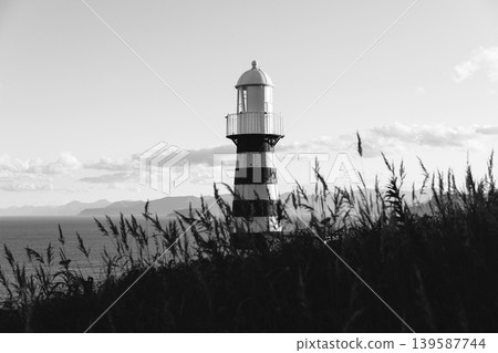 Mayachny Cape lighthouse on Kamchatka coast, black and white seascape view 139587744