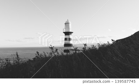 Mayachny Cape lighthouse on coastal cliff above the Pacific Ocean, Kamchatka Mayachny Cape lighthouse on coastal cliff above the Pacific Ocean, Kamchatka 139587745