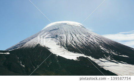 Snow-capped Avachinsky volcano cone under clear blue sky, Kamchatka view Snow-capped Avachinsky volcano cone under clear blue sky, Kamchatka view 139587754