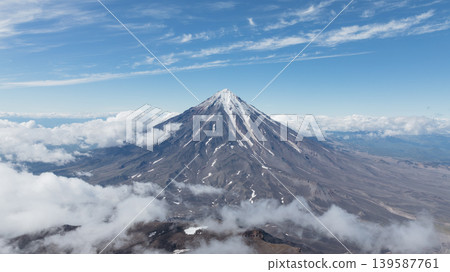 Aerial view of Koryaksky volcano above clouds on Kamchatka Peninsula, Russia Aerial view of Koryaksky volcano above clouds on Kamchatka Peninsula, Russia 139587761