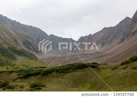 Vachkazhets mountain range valley landscape with rocky peaks, Kamchatka wilderness Vachkazhets mountain range valley landscape with rocky peaks, Kamchatka wilderness 139587788