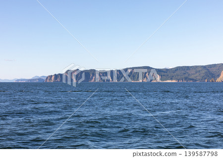 Coastal cliffs and calm sea in Avacha Bay, Kamchatka Peninsula, Russia 139587798