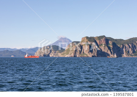 Scenic Avacha Bay seascape with ships and volcano near Petropavlovsk-Kamchatsky Scenic Avacha Bay seascape with ships and volcano near Petropavlovsk-Kamchatsky 139587801