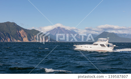 Speedboat cruising in Avacha Bay with volcanic mountains, Kamchatka seascape Speedboat cruising in Avacha Bay with volcanic mountains, Kamchatka seascape 139587807