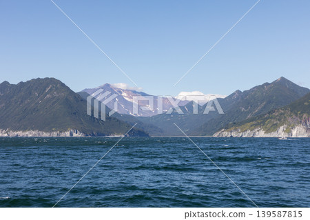 Coastal mountains and volcanic peak above the sea in Kamchatka peninsula, Russia Coastal mountains and volcanic peak above the sea in Kamchatka peninsula, Russia 139587815