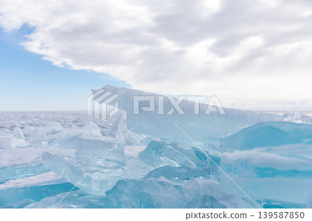 Turquoise ice hummocks and frozen lake landscape on Lake Baikal in winter Turquoise ice hummocks and frozen lake landscape on Lake Baikal in winter 139587850