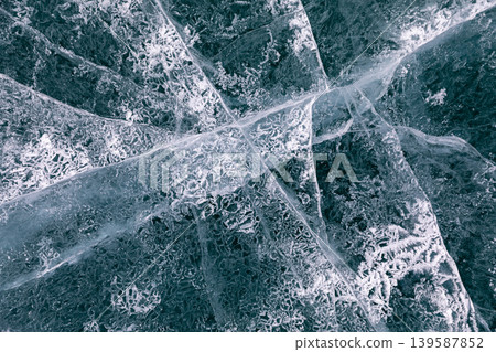 Abstract cracked ice texture on frozen Lake Baikal surface, winter background Abstract cracked ice texture on frozen Lake Baikal surface, winter background 139587852