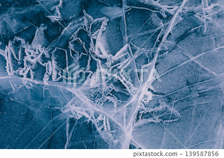 Frozen cracks and frost patterns on Lake Baikal ice, winter abstract texture Frozen cracks and frost patterns on Lake Baikal ice, winter abstract texture 139587856