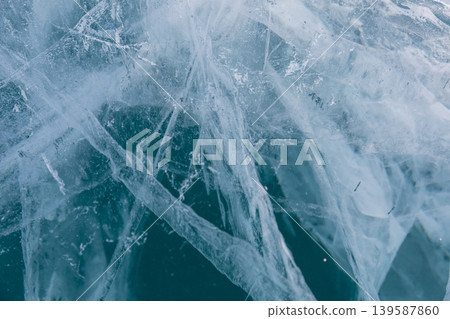 Abstract cracked blue ice texture on Lake Baikal in winter, close up background Abstract cracked blue ice texture on Lake Baikal in winter, close up background 139587860