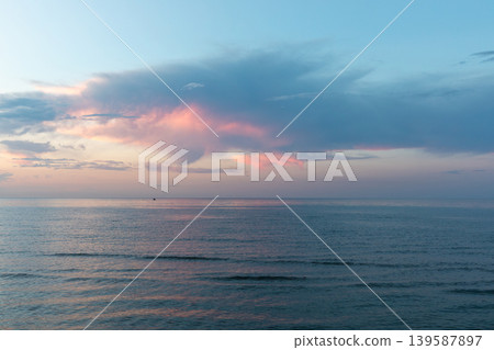 Calm sunset over the Caspian Sea horizon in Derbent with pastel clouds Calm sunset over the Caspian Sea horizon in Derbent with pastel clouds 139587897