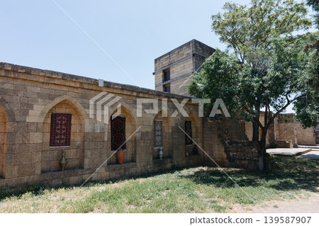 Naryn-Kala fortress stone courtyard with arched niches and carpets in Derbent 139587907