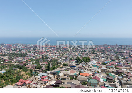 Panoramic cityscape of Derbent with Caspian Sea coastline on a clear day Panoramic cityscape of Derbent with Caspian Sea coastline on a clear day 139587908