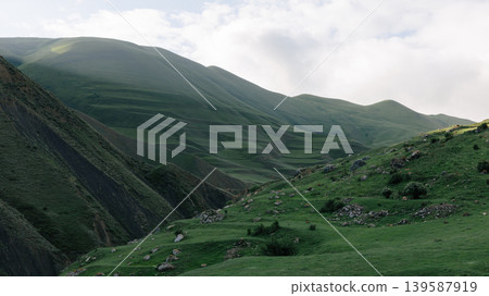 Mountain road to Mount Shalbuzdag through green highlands in Dagestan 139587919