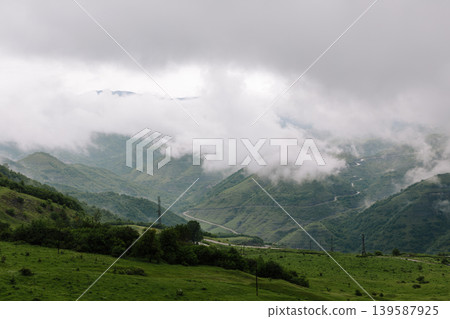 Misty mountain valley landscape with winding road in Dagestan, Caucasus region 139587925